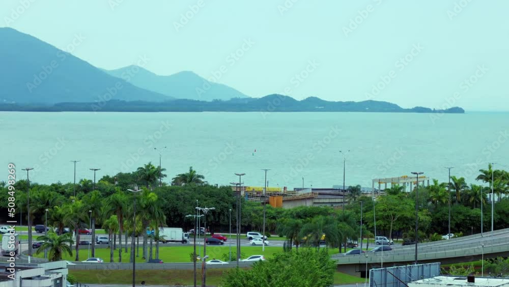 View overlooking the town. City in the tropics in cloudy weather. The rain starts in the city. City, palm trees, sea, coast, mountains, sky. Urban landscape. Timelapse video. View overlooking the town. City in the tropics in cloudy weather. The rain starts in the city. City, palm trees, sea, coast, mountains, sky. Urban landscape. Timelapse video.