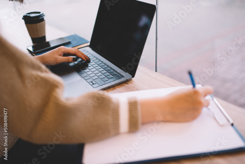 Young millennial asian girl working in cafe