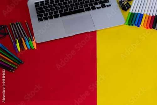 desk with School supplies close up laptop and markers photo