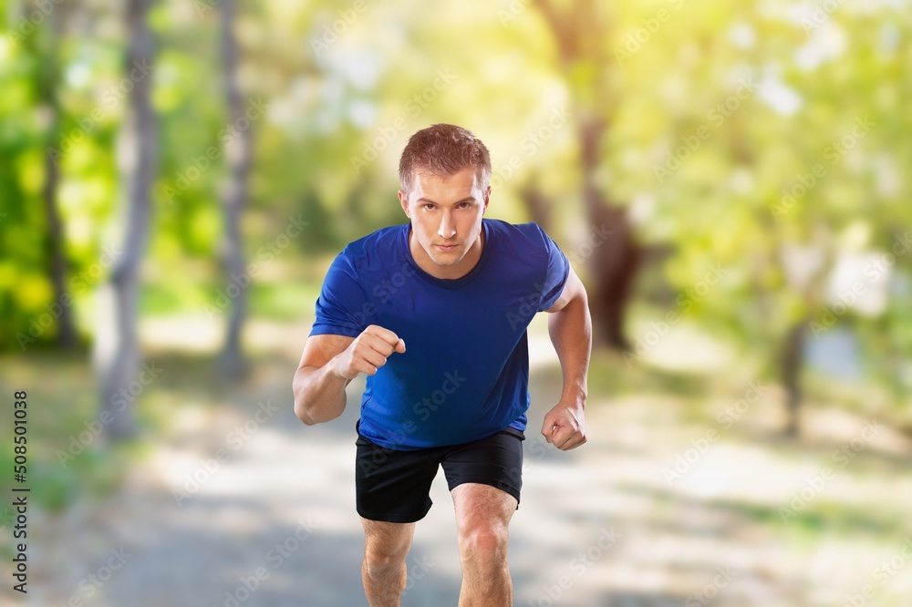 Young strong fitness man running in park Young strong fitness man running in park