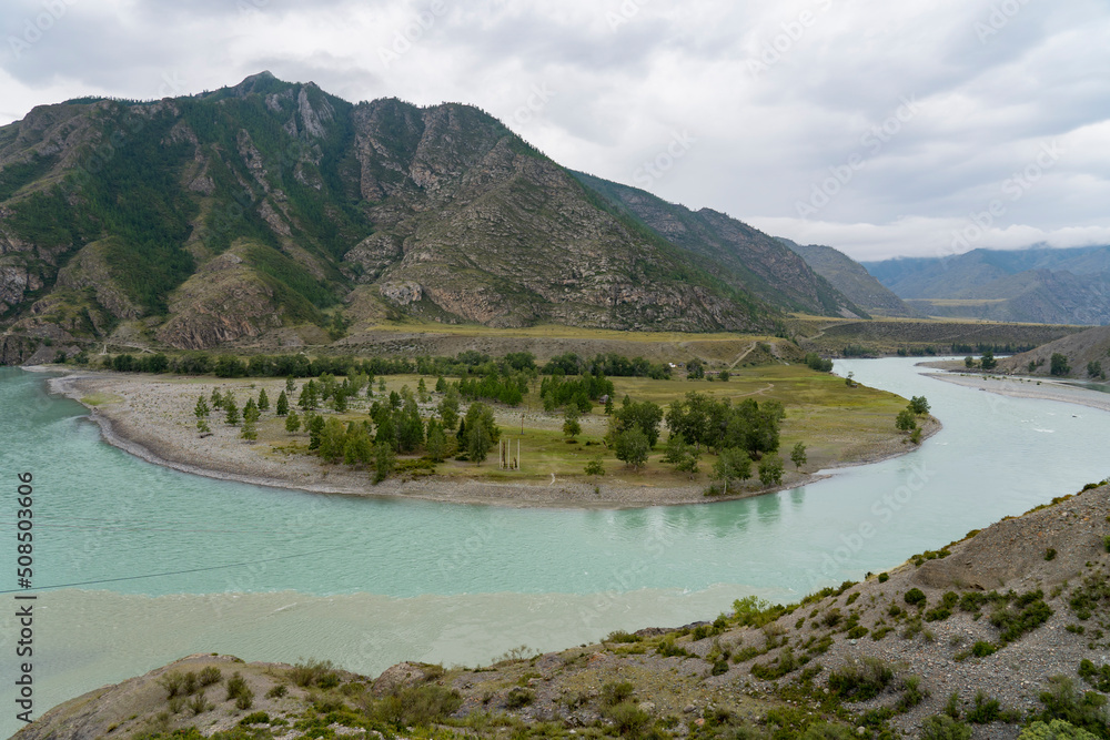 The Chuya and Katun Rivers merge in the mountains. Altai, Siberia, Russia. View of the beautiful landscape in Altai, Altai foothills, view of the valley, selective focus, tourism in Russia.