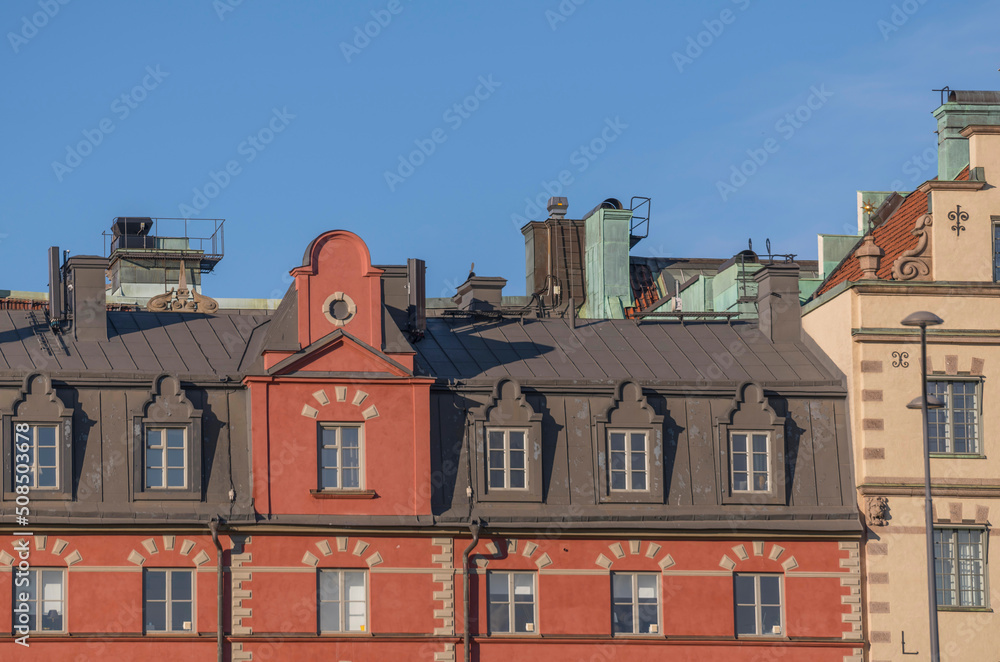 Fototapeta premium Details of facades on old 1700s houses in the old town Gamla Stan an evening sunny summer day in Stockholm