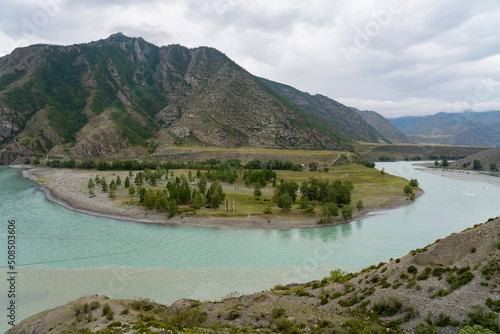 The Chuya and Katun Rivers merge in the mountains. Altai, Siberia, Russia. View of the beautiful landscape in Altai, Altai foothills, view of the valley, selective focus, tourism in Russia.