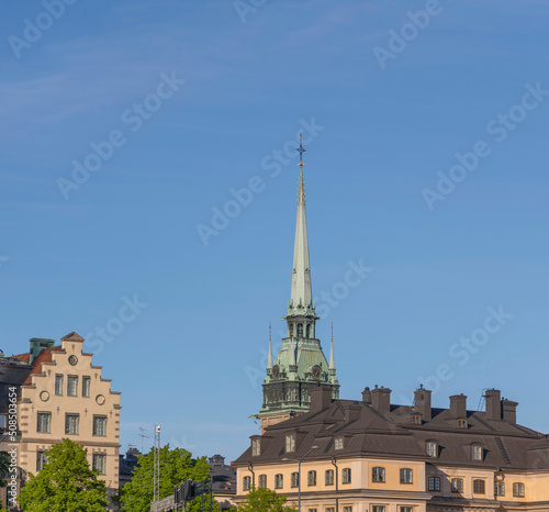 Old 1700s houses and the German church in the old town Gamla Stan an evening sunny summer day in Stockholm
