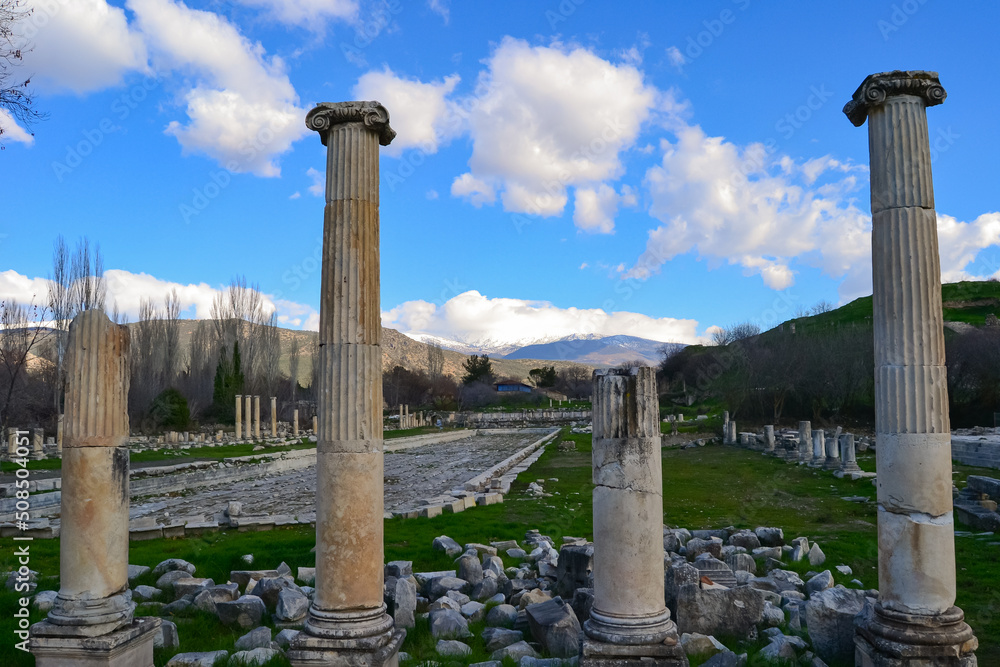 Distant view of the ancient city of Aphrodisias. Historical ruins under blue sky.