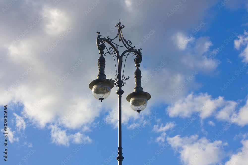  Old light poles against a blue sky