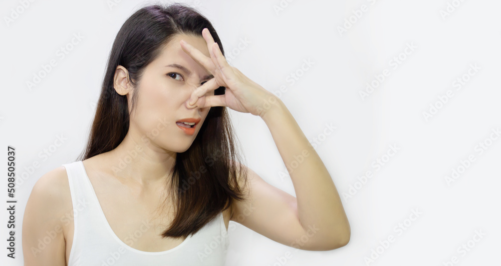 Asian beautiful women who covers and touching nose, looks away, something stinks, very bad smell with an unhappy Asian beautiful women who covers and touching nose, looks away, something stinks, very bad smell with an unhappy