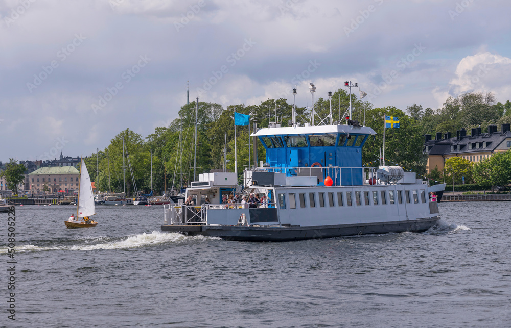 Ferry passing the bay Vasadjupet between the islands Djurgården and Kastellholmen a sunny summer day in Stockholm Ferry passing the bay Vasadjupet between the islands Djurgården and Kastellholmen a sunny summer day in Stockholm