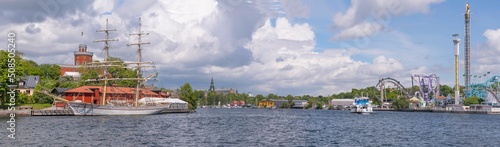Ferry passing the bay Vasadjupet between the islands Djurgården and Kastellholmen a sunny summer day in Stockholm