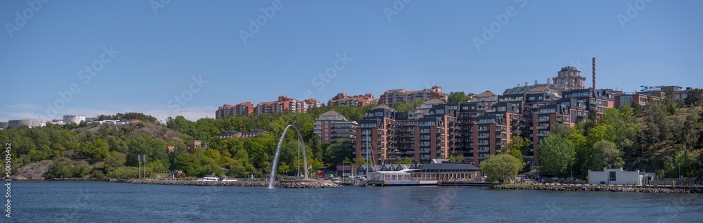 Water statue in a harbor and apartment houses in the archipelago a sunny day in Stockholm