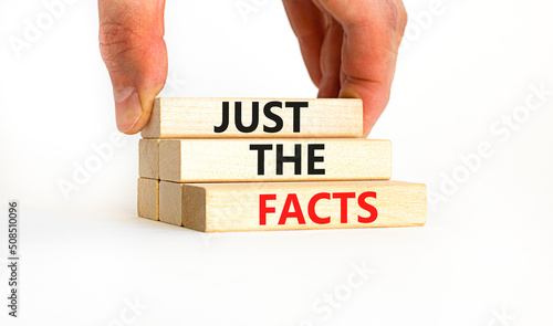 Just the facts symbol. Concept words Just the facts on wooden blocks on a beautiful white table white background. Businessman hand. Business and just the facts concept. Copy space.