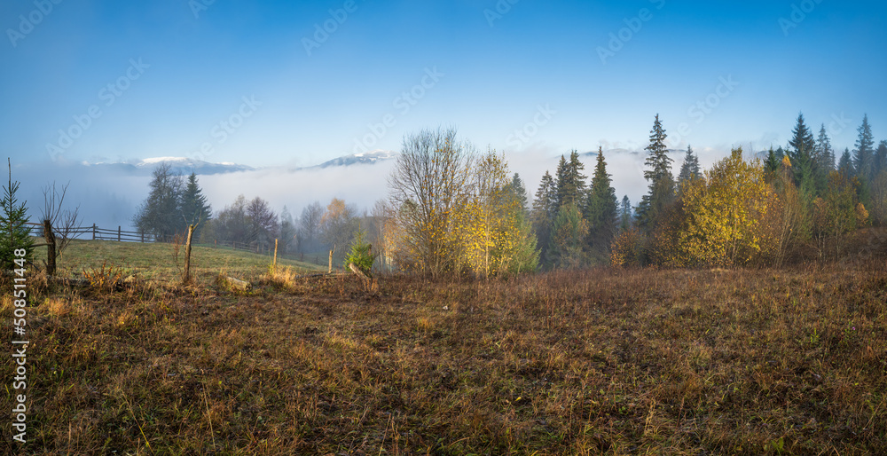 Fototapeta premium Cloudy and foggy morning late autumn mountains scene. Peaceful picturesque traveling, seasonal, nature and countryside beauty concept scene. Carpathian Mountains, Ukraine.