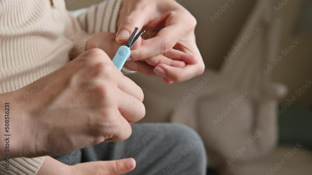 Mom cuts her child's nails with scissors. Child care, health and hygiene concept. Woman's hands with scissors and child's hands close-up. Toddler manicure, Home baby care Mom cuts her child's nails with scissors. Child care, health and hygiene concept. Woman's hands with scissors and child's hands close-up. Toddler manicure, Home baby care