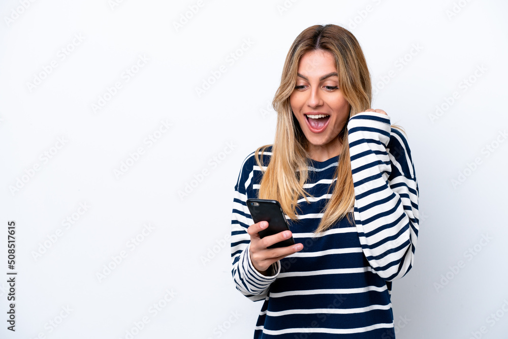 Young Uruguayan woman isolated on white background surprised and sending a message Young Uruguayan woman isolated on white background surprised and sending a message