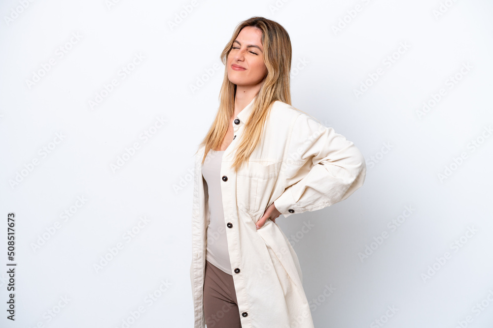 Young Uruguayan woman isolated on white background suffering from backache for having made an effort Young Uruguayan woman isolated on white background suffering from backache for having made an effort
