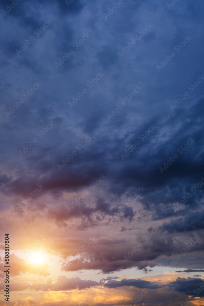 Obraz premium Thunderclouds with breaking rays sun at sunset.