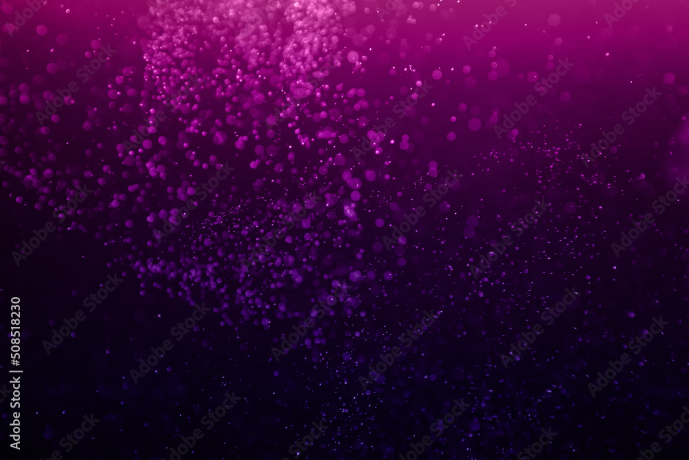 Purple sparkles on a black background. Blank for holiday, Christmas cards. Concept color of the year.
