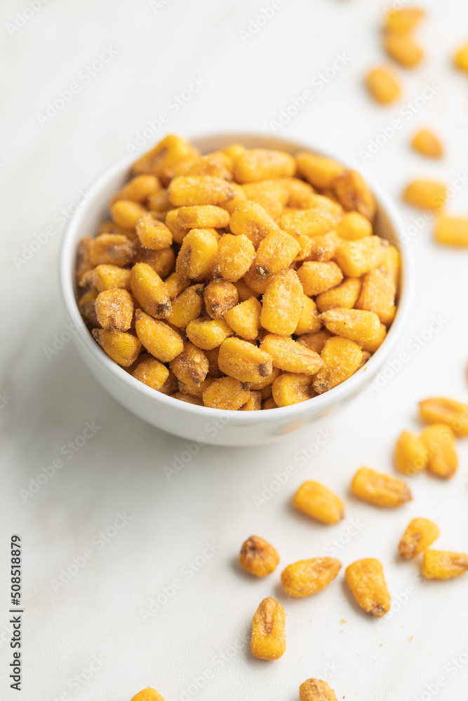 Roasted salted corn snack in bowl on white table. Roasted salted corn snack in bowl on white table.