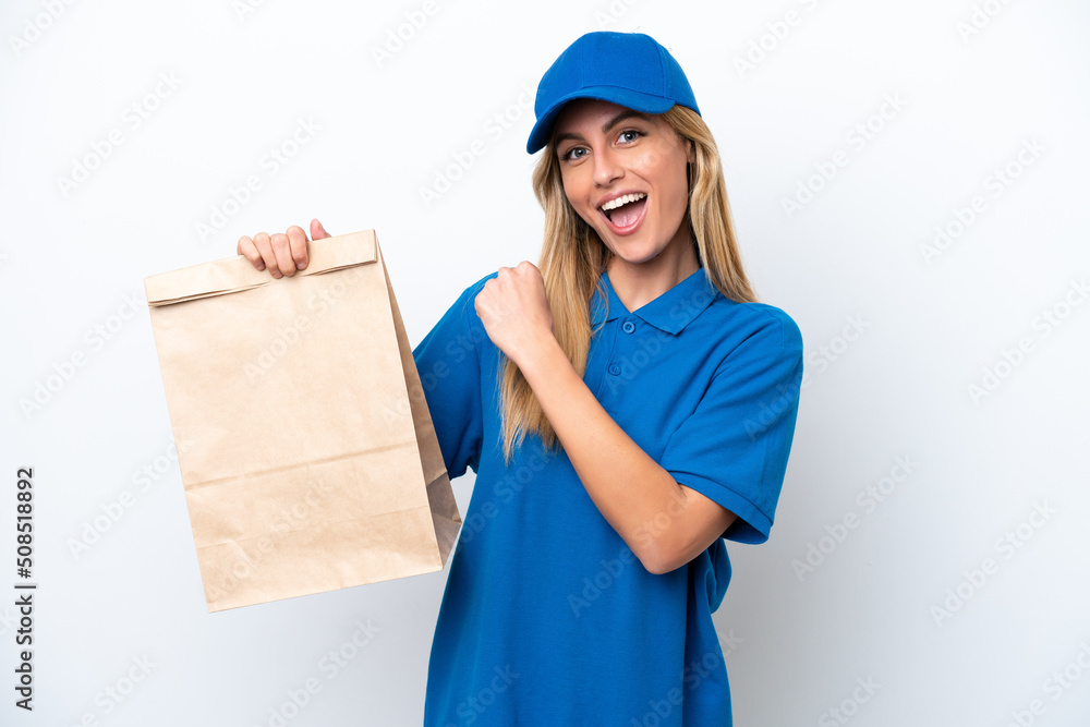 Young Uruguayan woman taking a bag of takeaway food isolated on white background celebrating a victory Young Uruguayan woman taking a bag of takeaway food isolated on white background celebrating a victory
