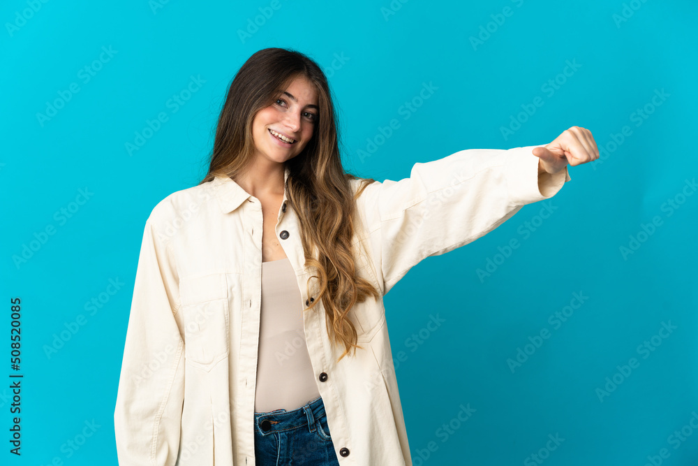 Young caucasian woman isolated on blue background giving a thumbs up gesture Young caucasian woman isolated on blue background giving a thumbs up gesture