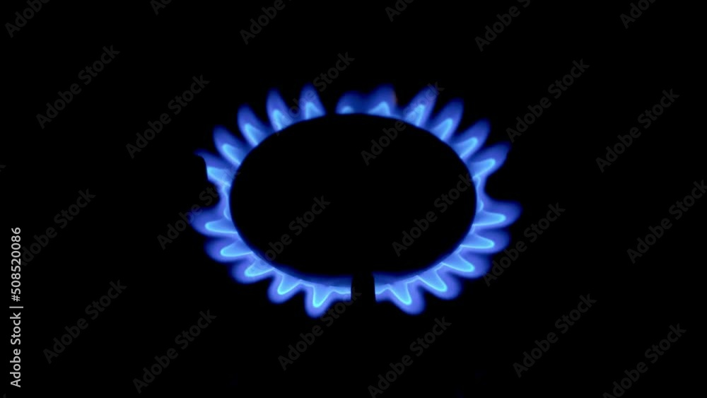 Person lights burner of gas kitchen stove with match. Flame goes. Natural gas is burning. Gas crisis. Close-up. Person lights burner of gas kitchen stove with match. Flame goes. Natural gas is burning. Gas crisis. Close-up.