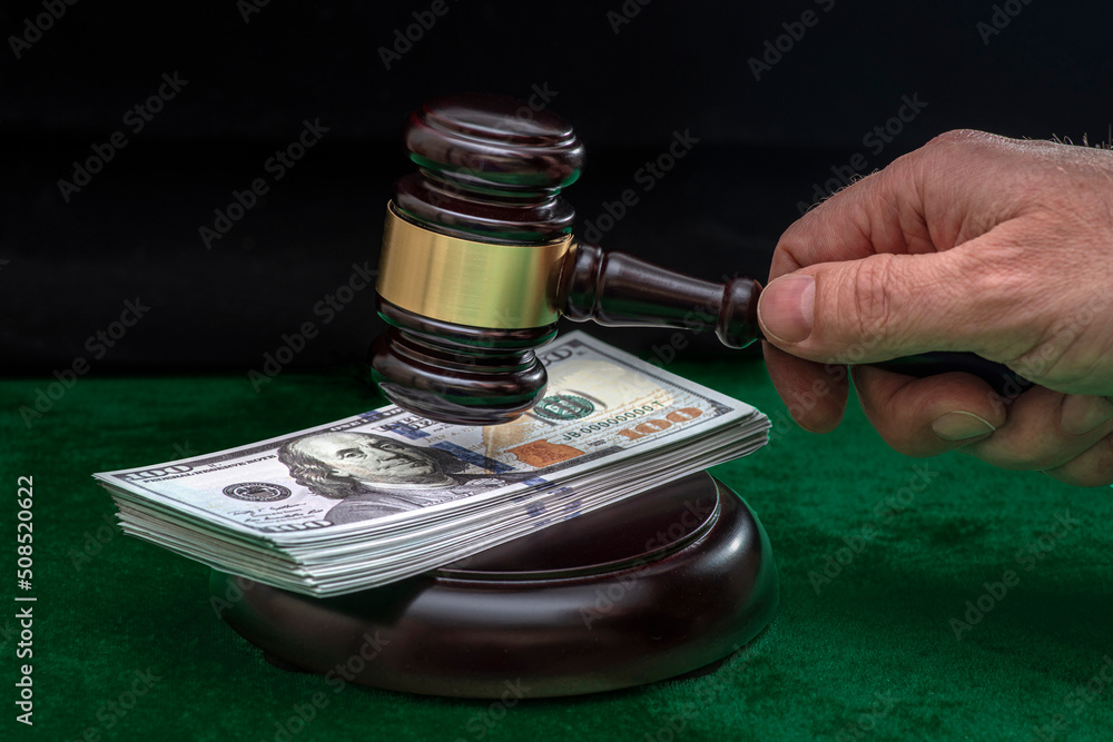 Judge and money concept. Judge's gavel on the table. Judge's hammer for verdict, justice judgment at courts of law. American One Hundred Dollar Bill, corruption, cost, finances, expenses, salary