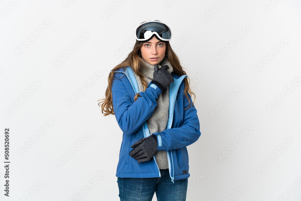 Skier girl with snowboarding glasses isolated on white background thinking