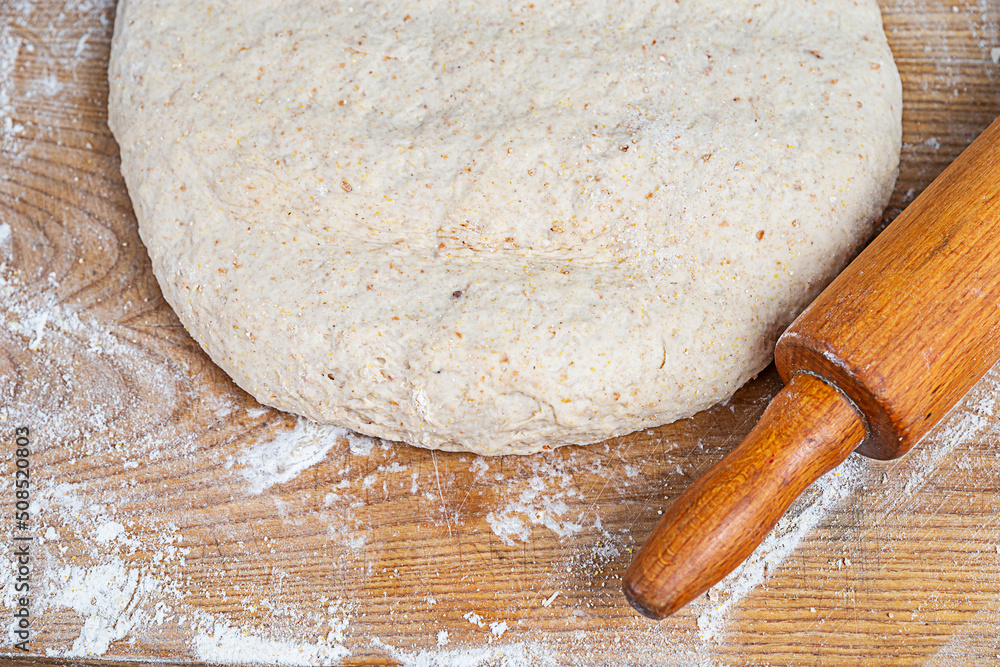 Making homemade dough for bread, pastry, and cookie. Wood rolling pin, flour, eggs. Rural food cooking. Top view Making homemade dough for bread, pastry, and cookie. Wood rolling pin, flour, eggs. Rural food cooking. Top view