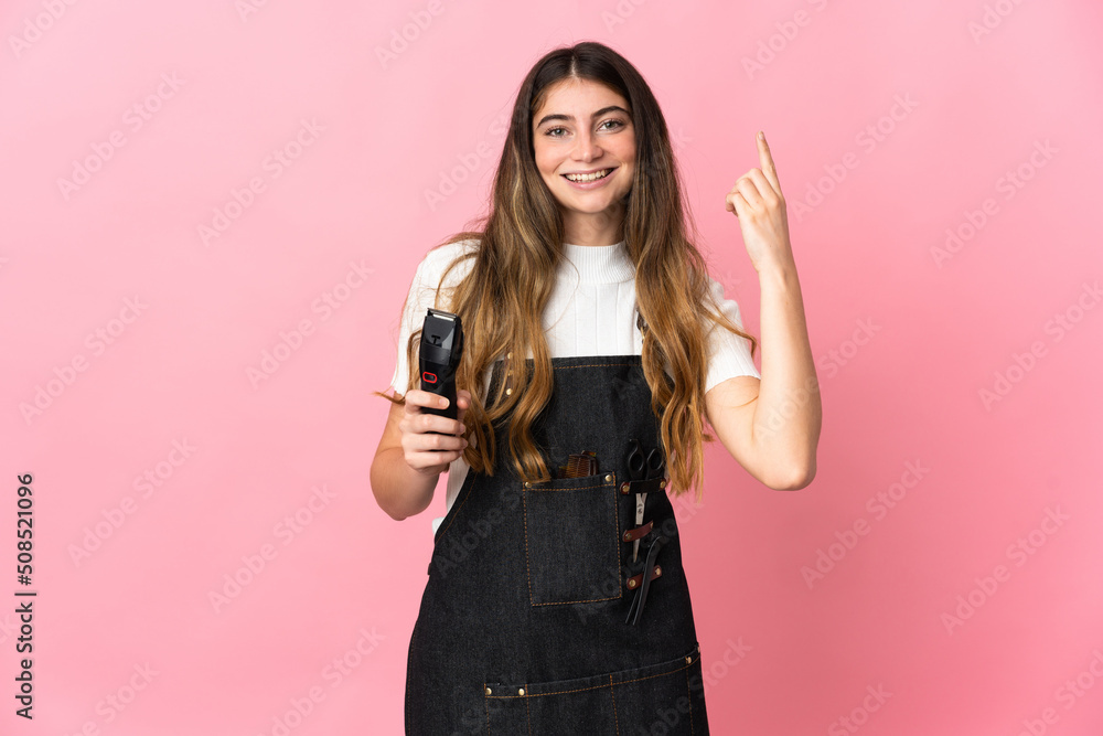 Young hairdresser woman isolated on pink background pointing up a great idea Young hairdresser woman isolated on pink background pointing up a great idea