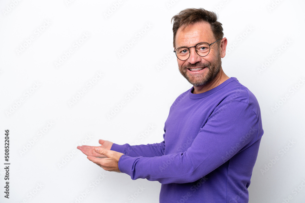 Middle age caucasian man isolated on white background extending hands to the side for inviting to come Middle age caucasian man isolated on white background extending hands to the side for inviting to come