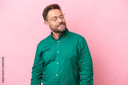Middle age caucasian man isolated on pink background . Portrait © luismolinero