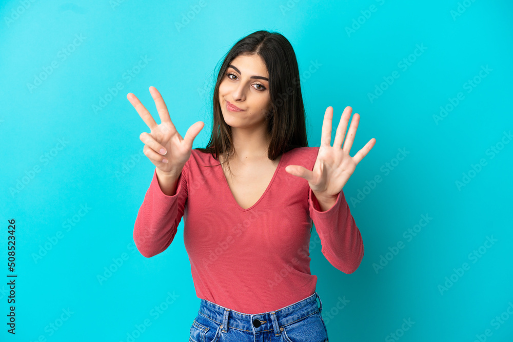 Young caucasian woman isolated on blue background counting eight with fingers Young caucasian woman isolated on blue background counting eight with fingers