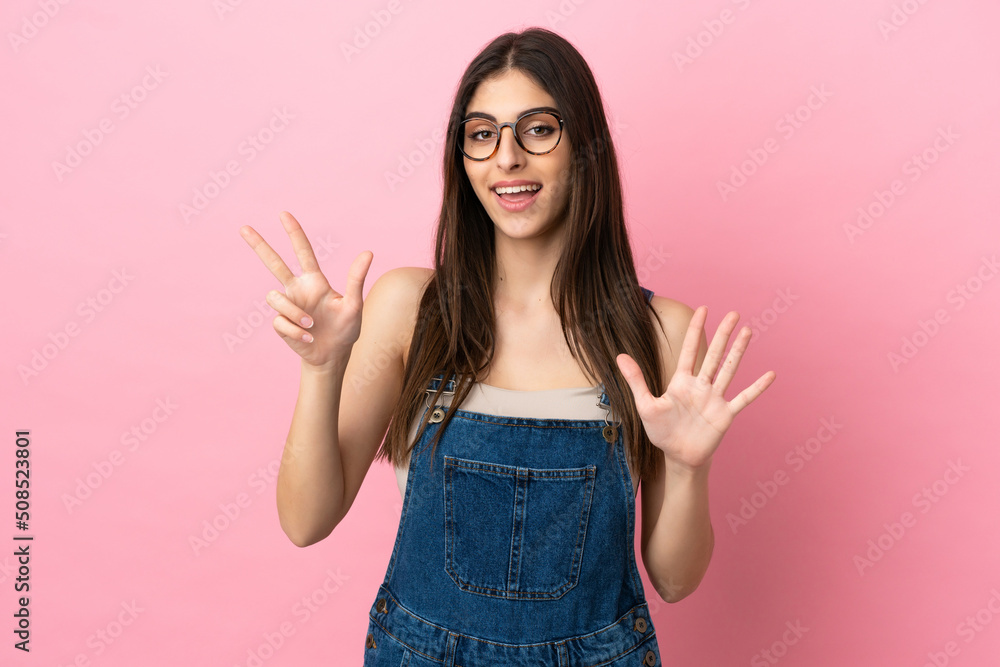 Young caucasian woman isolated on pink background counting eight with fingers Young caucasian woman isolated on pink background counting eight with fingers