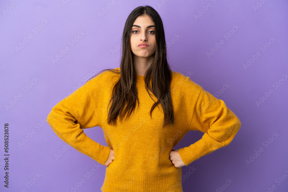 Young caucasian woman isolated on purple background angry