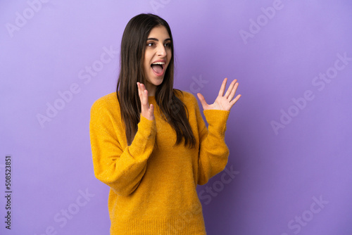 Young caucasian woman isolated on purple background with surprise facial expression © luismolinero