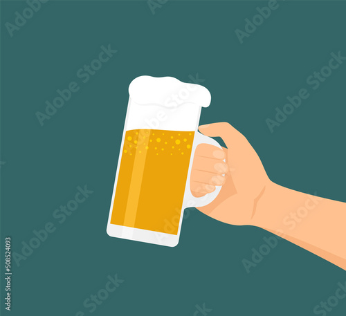 Male hand holding a glass of frothy beer on a blue and green background