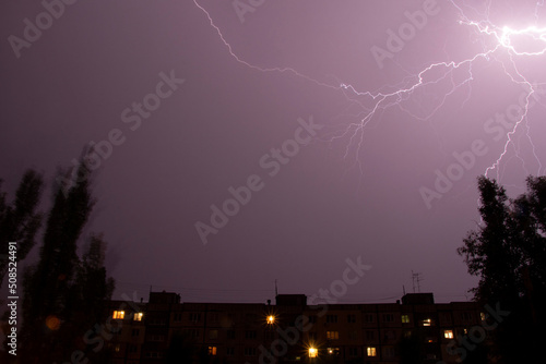 Lightning at night with heavy rain and thunder over Ukraine, lightning over the city in the night sky