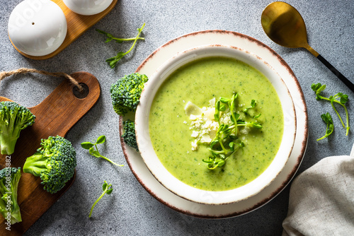 Broccoli cream soup with parmesan. Healthy green soup, vegan dish. Top view at stone table. photo