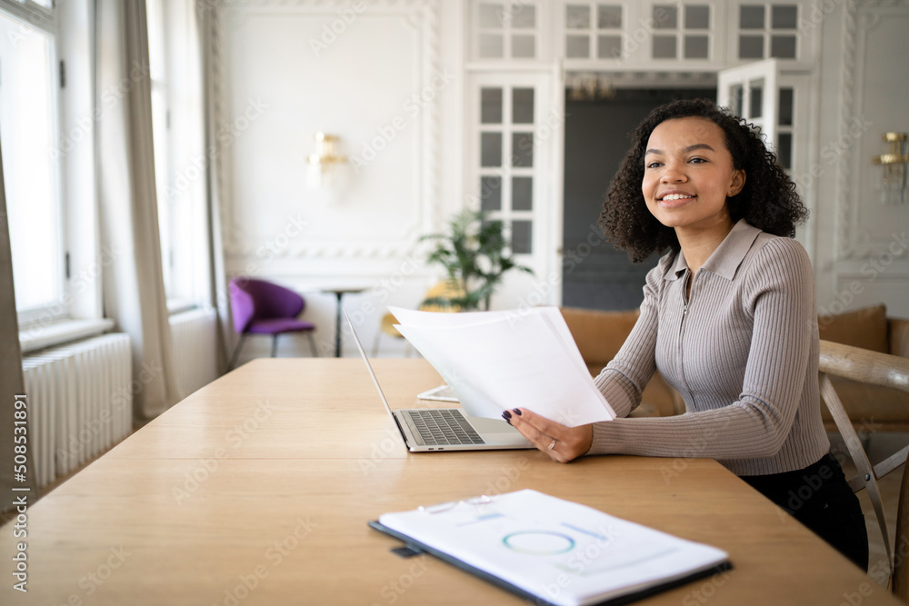 Finance and budget uses a laptop a woman with glasses a manager works in the office a report in the company documents Finance and budget uses a laptop a woman with glasses a manager works in the office a report in the company documents