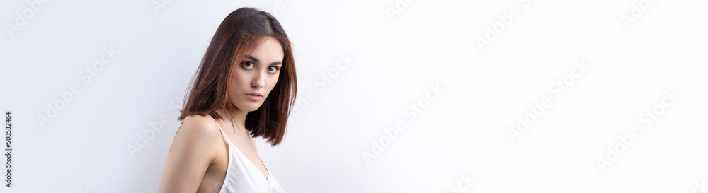 Beautiful smiling woman with clean skin, natural make-up and white teeth on a gray background Beautiful smiling woman with clean skin, natural make-up and white teeth on a gray background