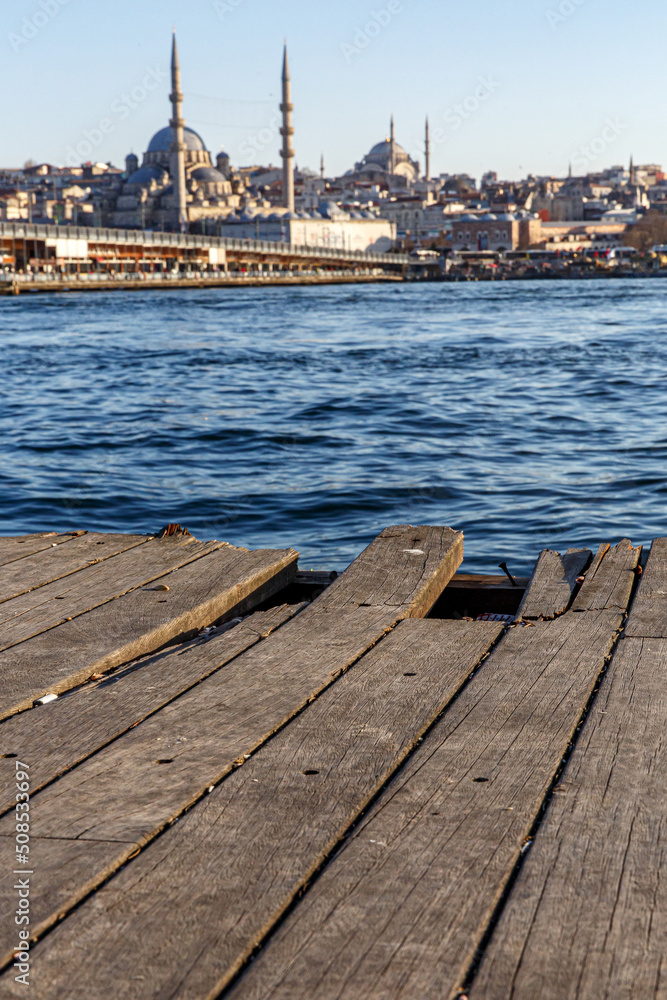 Wooden pier in old Istanbul. Boards with a background of the Bosphorus and mosques.