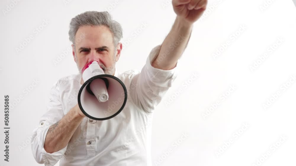 European gray-haired corporate businessman in his 50s with loudspeaker - studio shot isolated on white background. High quality 4k footage European gray-haired corporate businessman in his 50s with loudspeaker - studio shot isolated on white background. High quality 4k footage