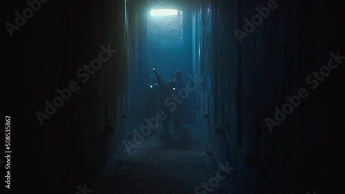 Children with flashlights walking through dark tunnels