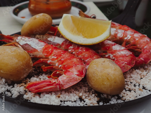 Canarian plate with potato, fish with red scales and big shrimps. Typical canarian food in Restaurant  photo