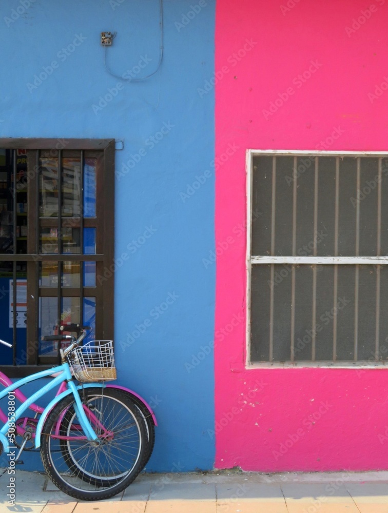 bicycle in front of a colorful house