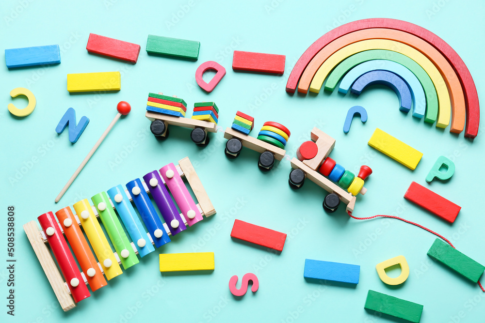 Toy train with building blocks and xylophone on blue background Toy train with building blocks and xylophone on blue background