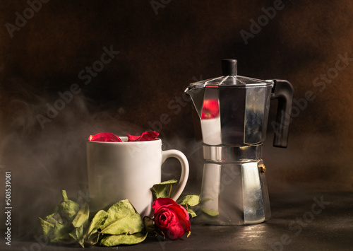 Kenyan style coffee pot with a white coffee cup surrounded by flowers. Elegant coffee shop concept