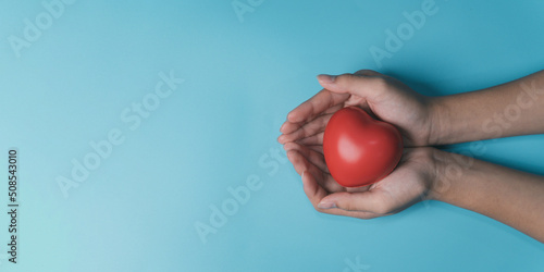 hands holding red heart, health care, love, organ donation, mindfulness, wellbeing, family insurance and CSR concept, world heart day, world health day, National Organ Donor Day, praying concept