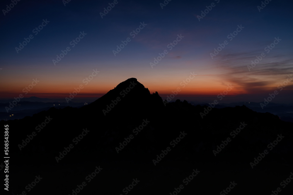 Scenic view of mountains against sky during sunrise Scenic view of mountains against sky during sunrise