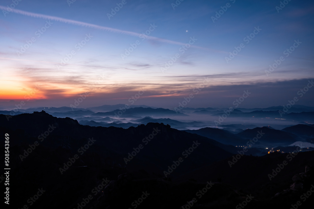 Scenic view of mountains against sky during sunrise Scenic view of mountains against sky during sunrise
